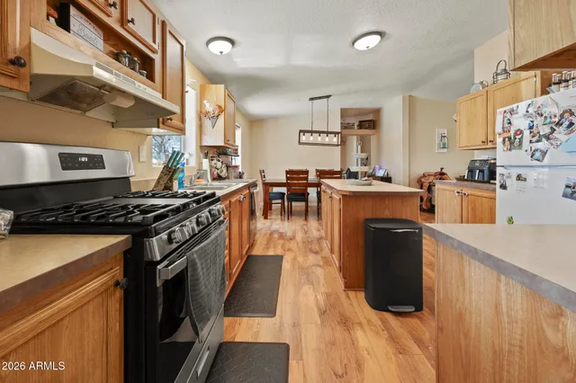 a kitchen with stove top oven and cabinets