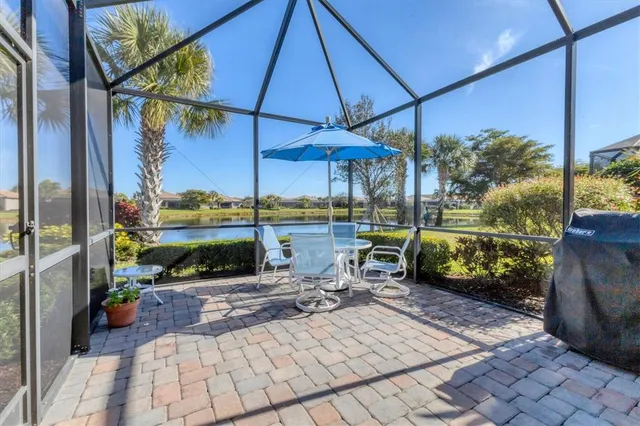 a view of a patio with a table and chairs under an umbrella