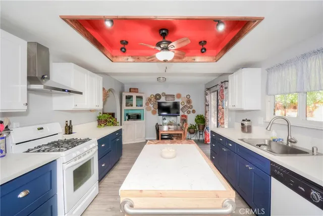 a large kitchen with stainless steel appliances kitchen island granite countertop a sink dishwasher stove and cabinets with wooden floor