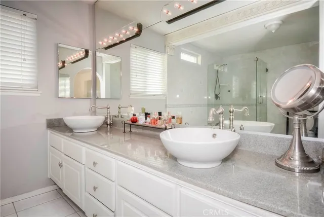 a spacious bathroom with a double vanity sink and a mirror