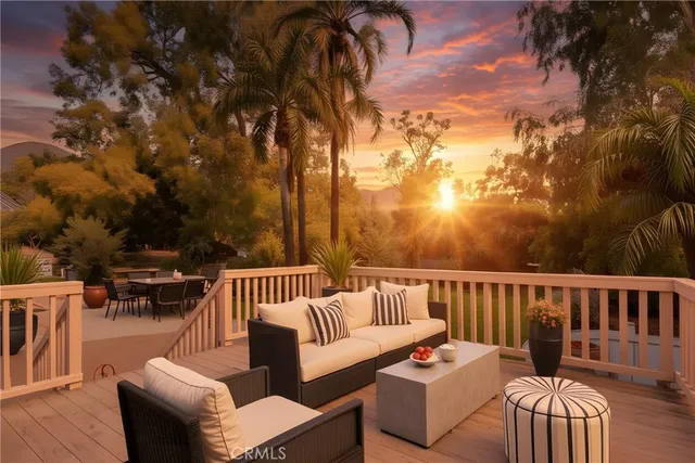 a balcony with wooden floor and outdoor seating