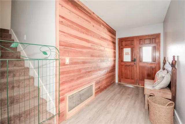 a view of entryway and hall with wooden floor