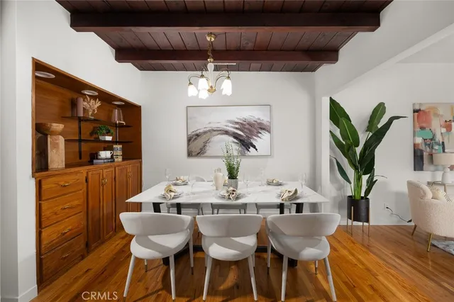 a kitchen with a table chairs sink and cabinets