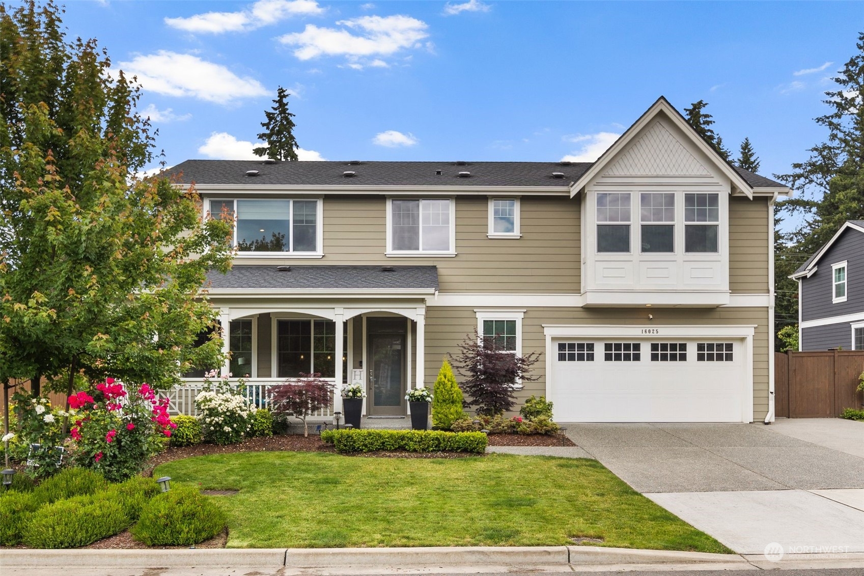 a front view of a house with a yard and garage
