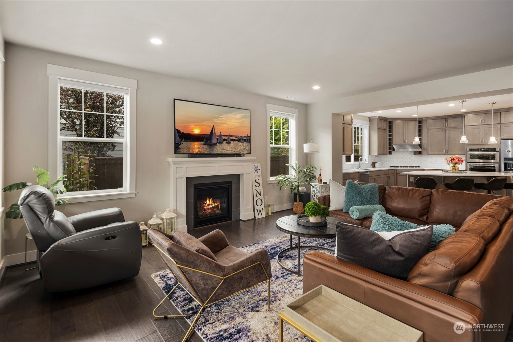 16025 Southeast 144th Street Renton, WA 98059 - Photo 14 of 40 a living room with furniture a flat screen tv and a fireplace