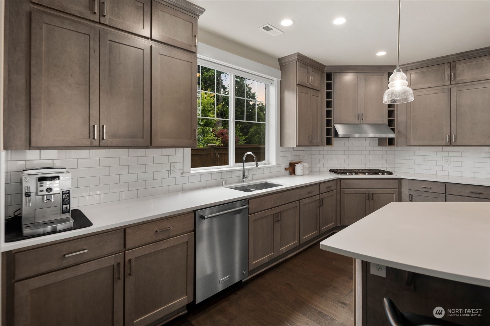 16025 Southeast 144th Street Renton, WA 98059 - Photo 22 of 40 a kitchen with a sink a window and stainless steel appliances