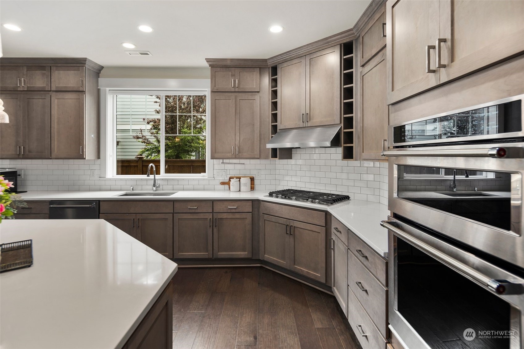 16025 Southeast 144th Street Renton, WA 98059 - Photo 25 of 40 a kitchen with stainless steel appliances granite countertop sink stove top oven and cabinets