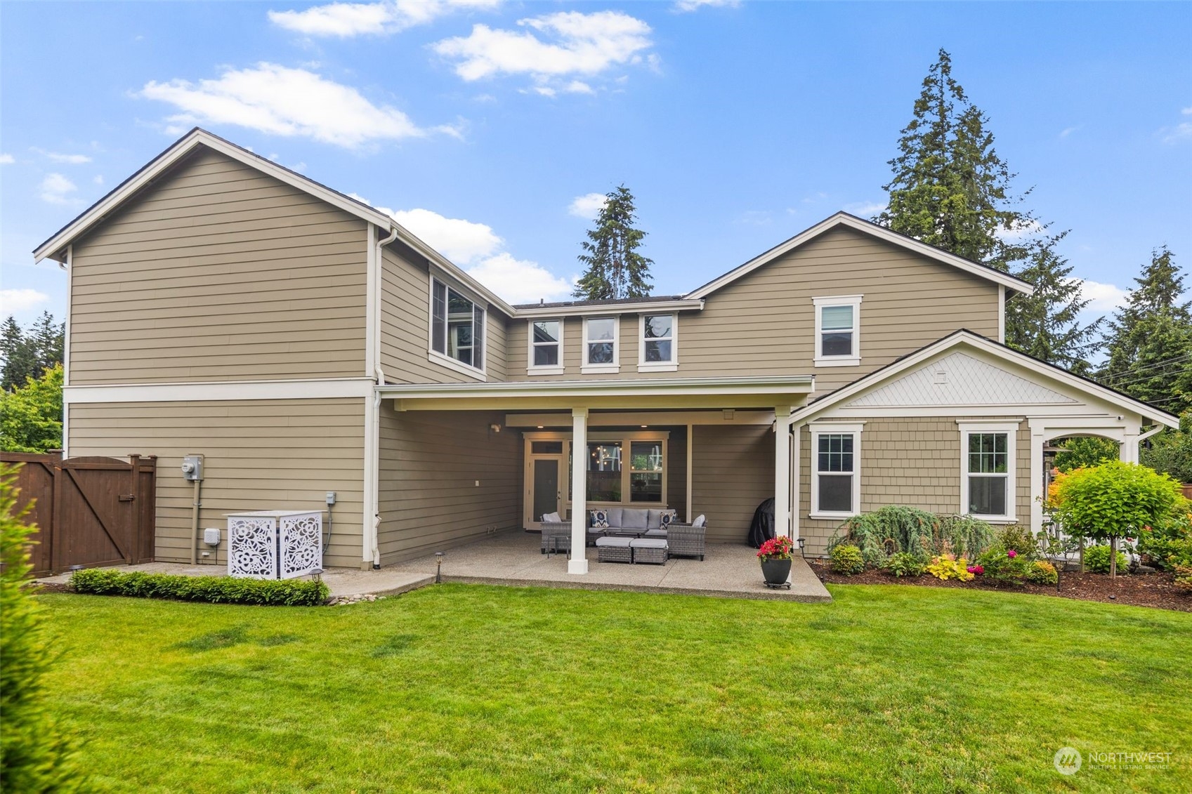 16025 Southeast 144th Street Renton, WA 98059 - Photo 6 of 40 a front view of a house with a yard and a garden