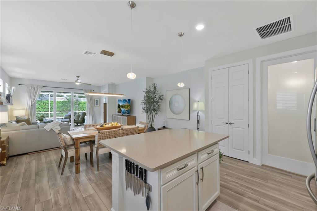 10787 Manatee Key Lane Estero, FL 33928 - Photo 9 of 31 an open kitchen with a table and chairs
