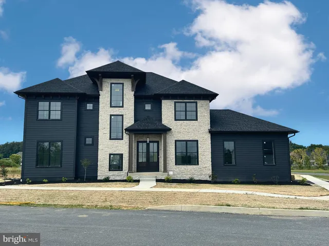 a front view of a house with a garden and pathway