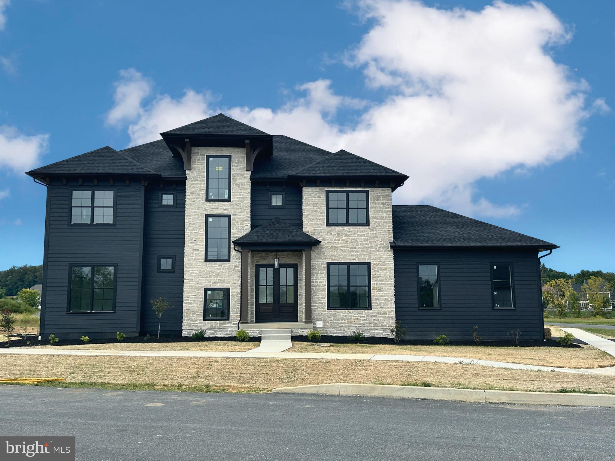 a front view of a house with a garden and pathway