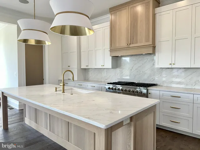a kitchen with stainless steel appliances granite countertop a sink a microwave and cabinets