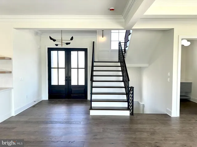 a view of entryway and hall with wooden floor