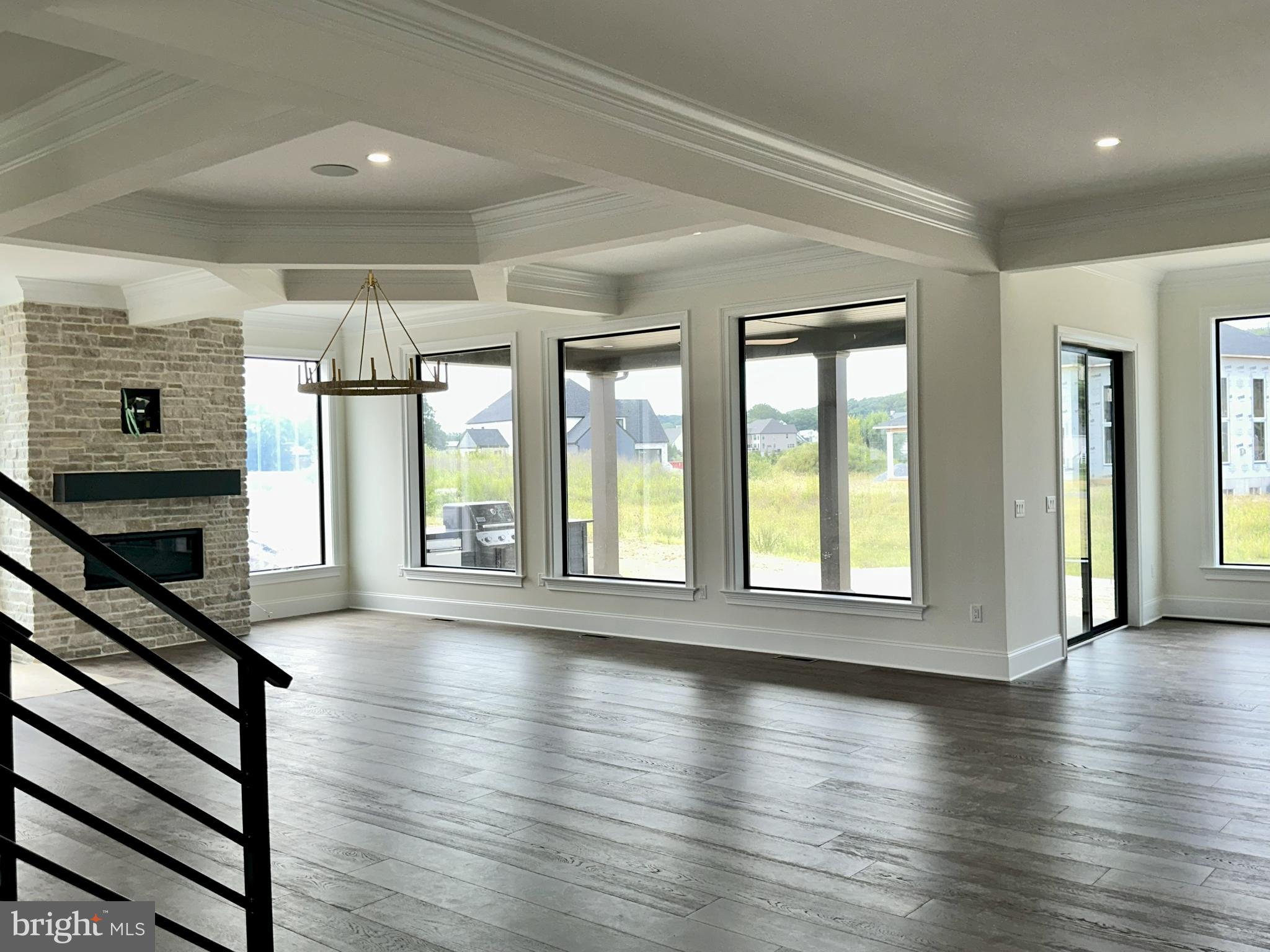 539 Sierra Lane Lancaster, PA 17601 - Photo 3 of 33 an empty room with wooden floor fireplace and windows
