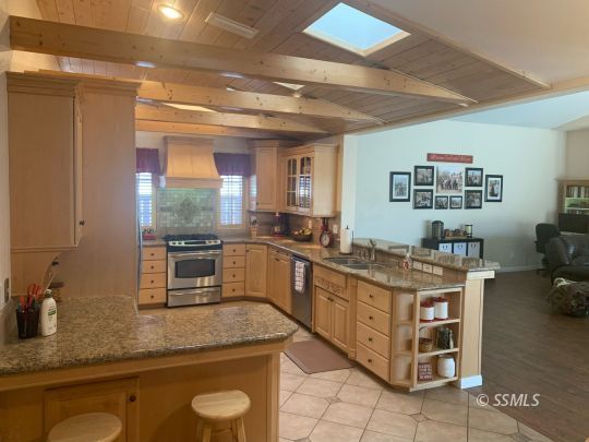600 South Erin Street Ridgecrest, CA 93555 - Photo 11 of 39 a kitchen with stainless steel appliances granite countertop a sink and a stove