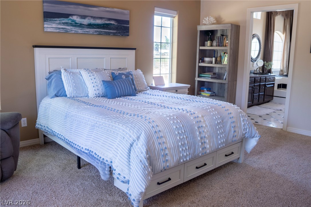 2775 Taylor Street Logandale, NV 89021 - Photo 6 of 41 This tranquil primary bedroom offers a private retreat with direct access to an en-suite bathroom.