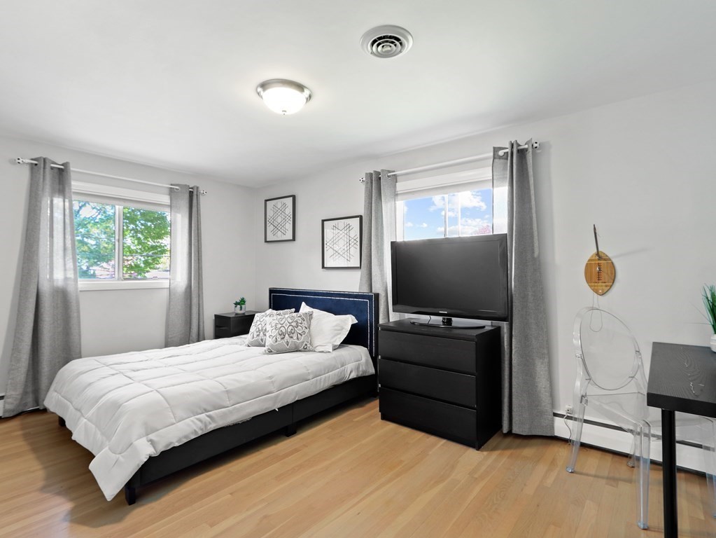 20 Woodbine Circle Needham, MA 02494 - Photo 14 of 34 a bedroom with a bed and a flat screen tv