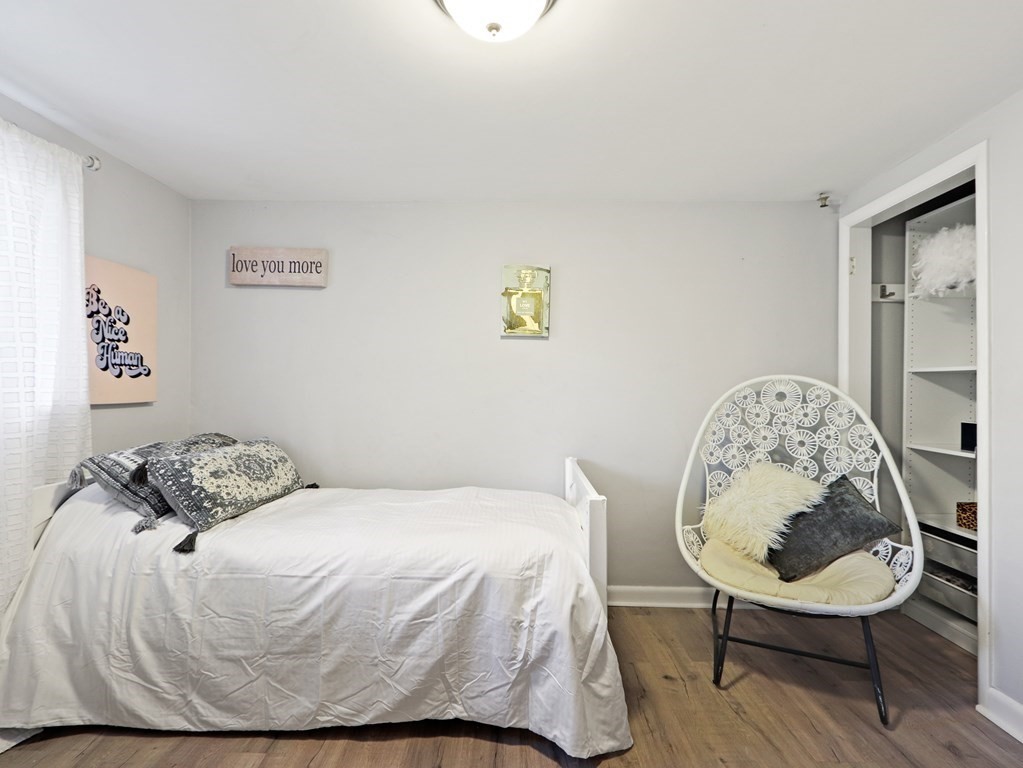 20 Woodbine Circle Needham, MA 02494 - Photo 20 of 34 a bedroom with a bed a mirror and a table in it