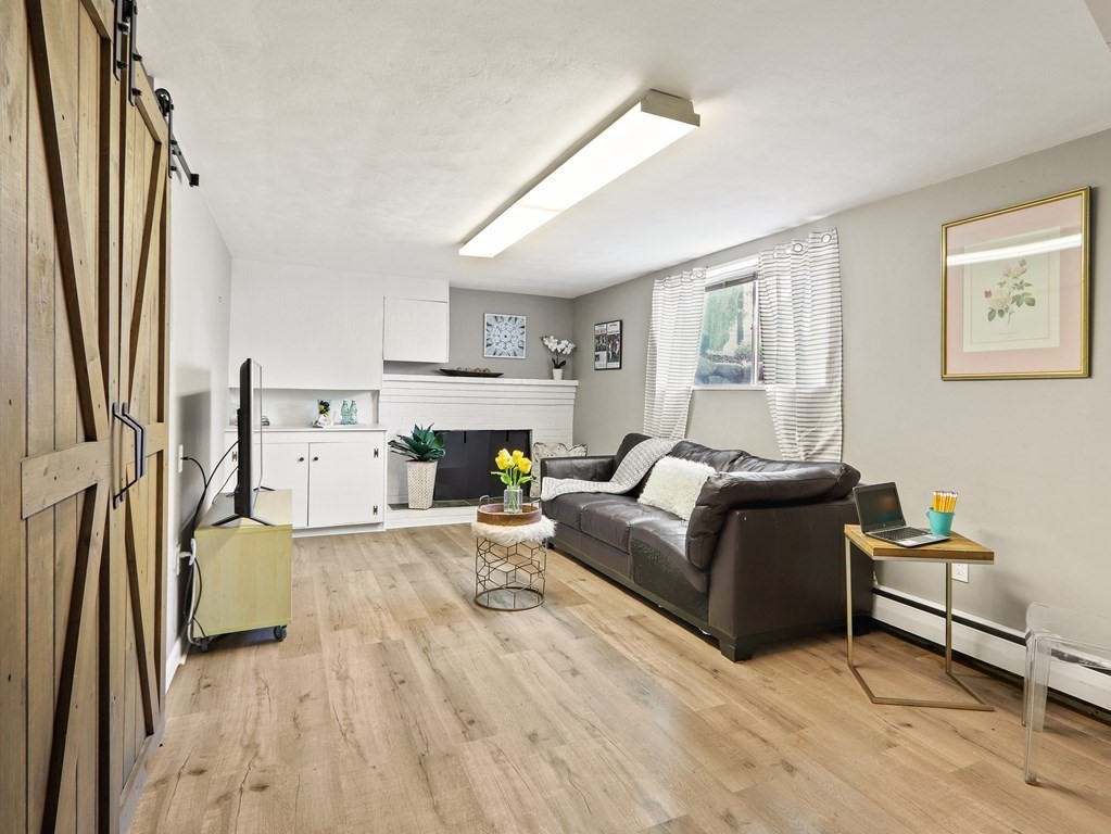 20 Woodbine Circle Needham, MA 02494 - Photo 22 of 34 a living room with furniture and a fireplace