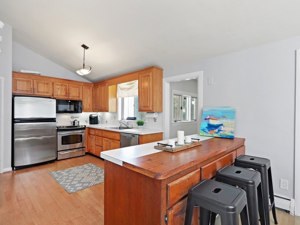 20 Woodbine Circle Needham, MA 02494 - Photo 8 of 34 a kitchen with a refrigerator a stove a sink and a refrigerator