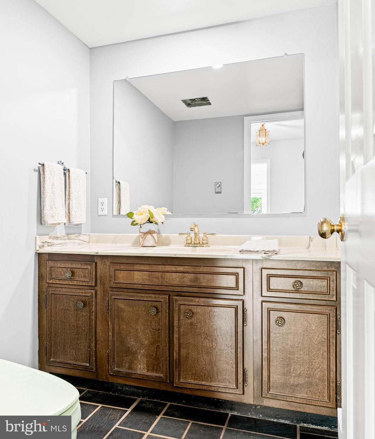 533 Gulph Road Wayne, PA 19087 - Photo 18 of 43 a bathroom with a granite countertop sink a toilet and mirror