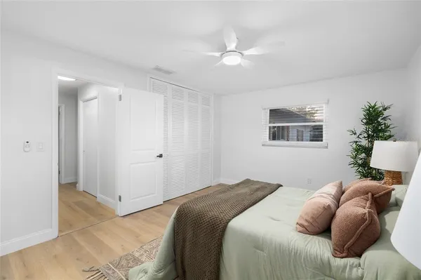 a bedroom with a bed and a chandelier