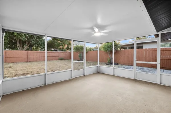 an empty room with sliding glass door and mountain view