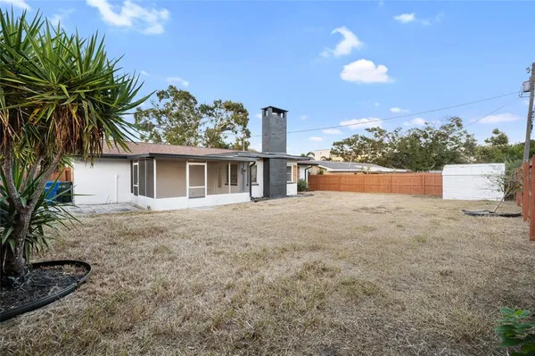 a view of house with backyard and garden