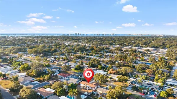 an aerial view of residential houses with city view