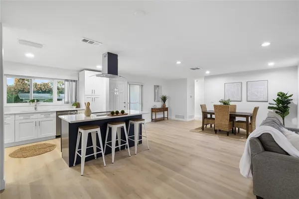 a kitchen with sink table and chairs