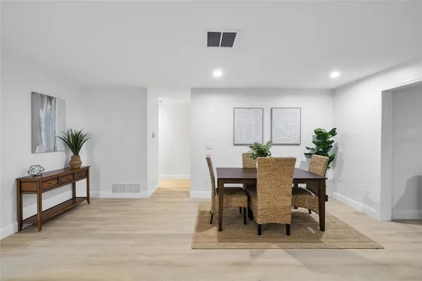 a view of a dining room with furniture and wooden floor