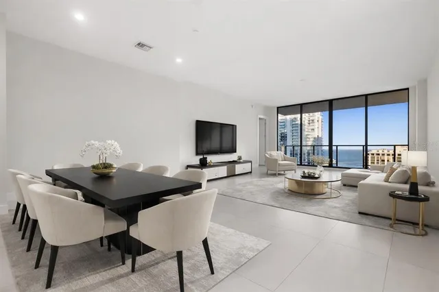a kitchen with a sink stainless steel appliances and view living room