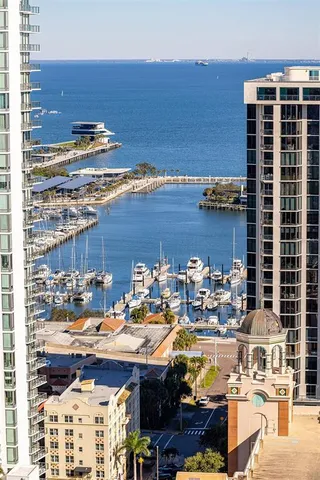 a spacious bedroom with a bed and a flat screen television
