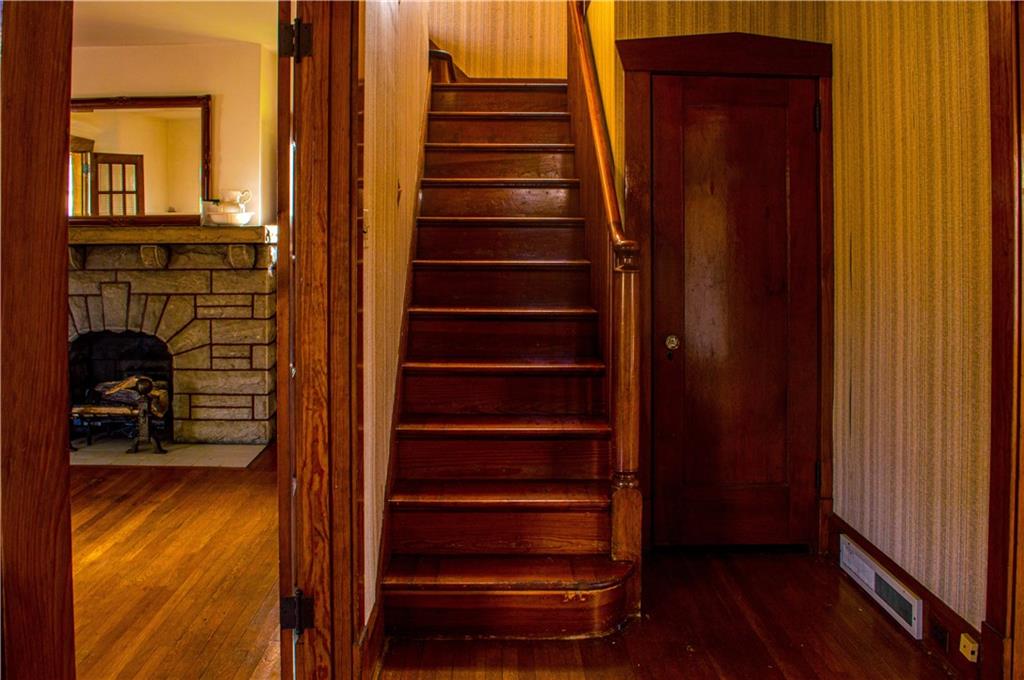 417 Darlington Road Beaver Falls, PA 15010 - Photo 4 of 24 A glimpse of the living room at left, coat closet in front of you and warm, rich hardwood floors, stairs, railing and trim.
