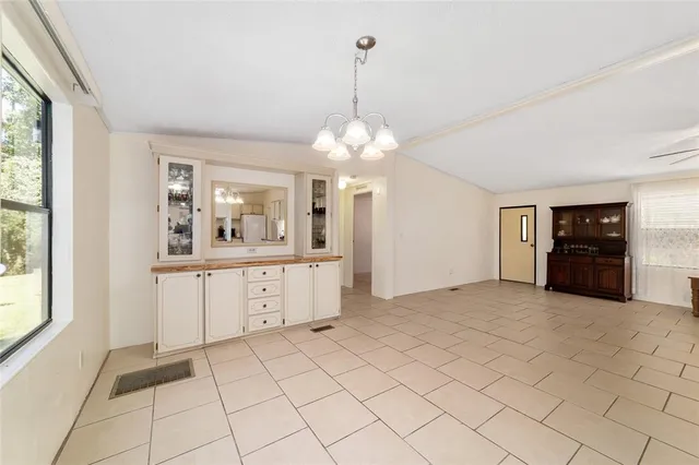 an empty room with closet and a ceiling fan