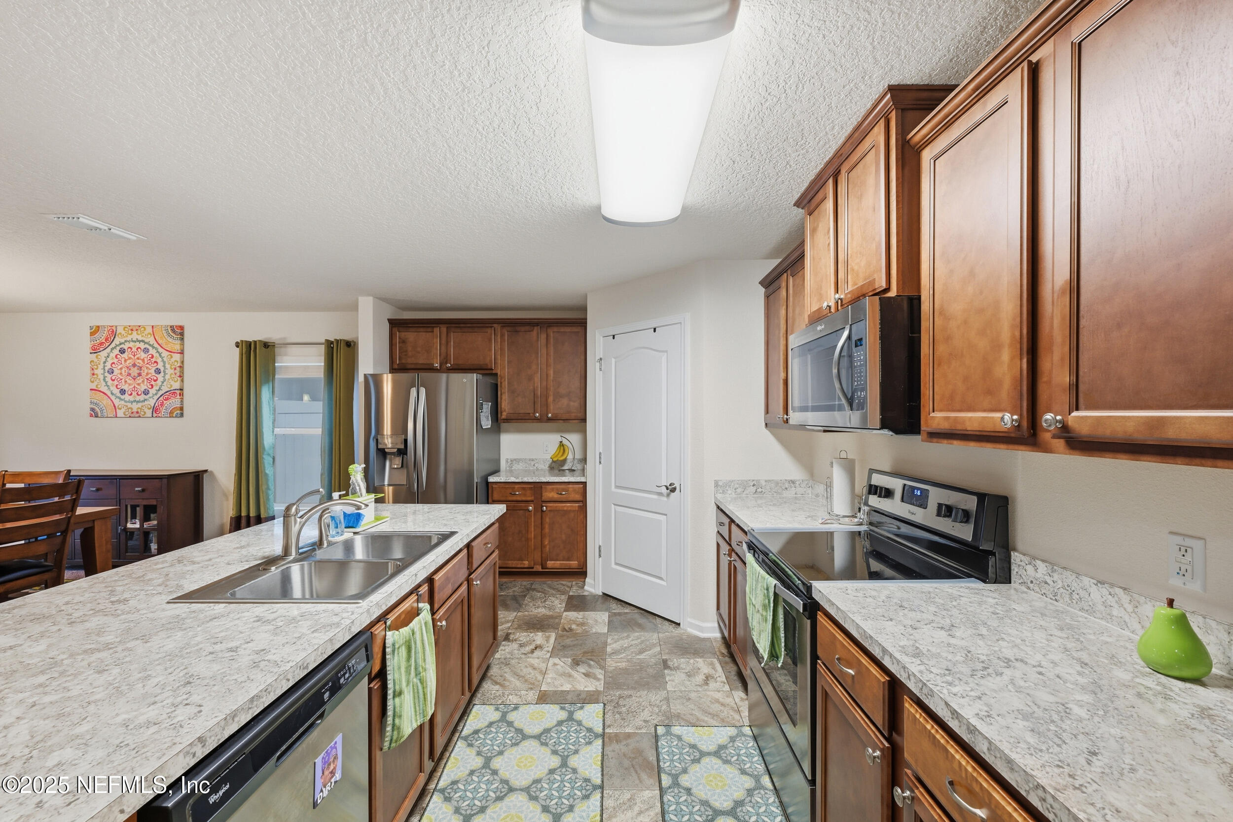 4068 Great Falls Loop Middleburg, FL 32068 - Photo 11 of 36 a kitchen with granite countertop a sink a stove and cabinets