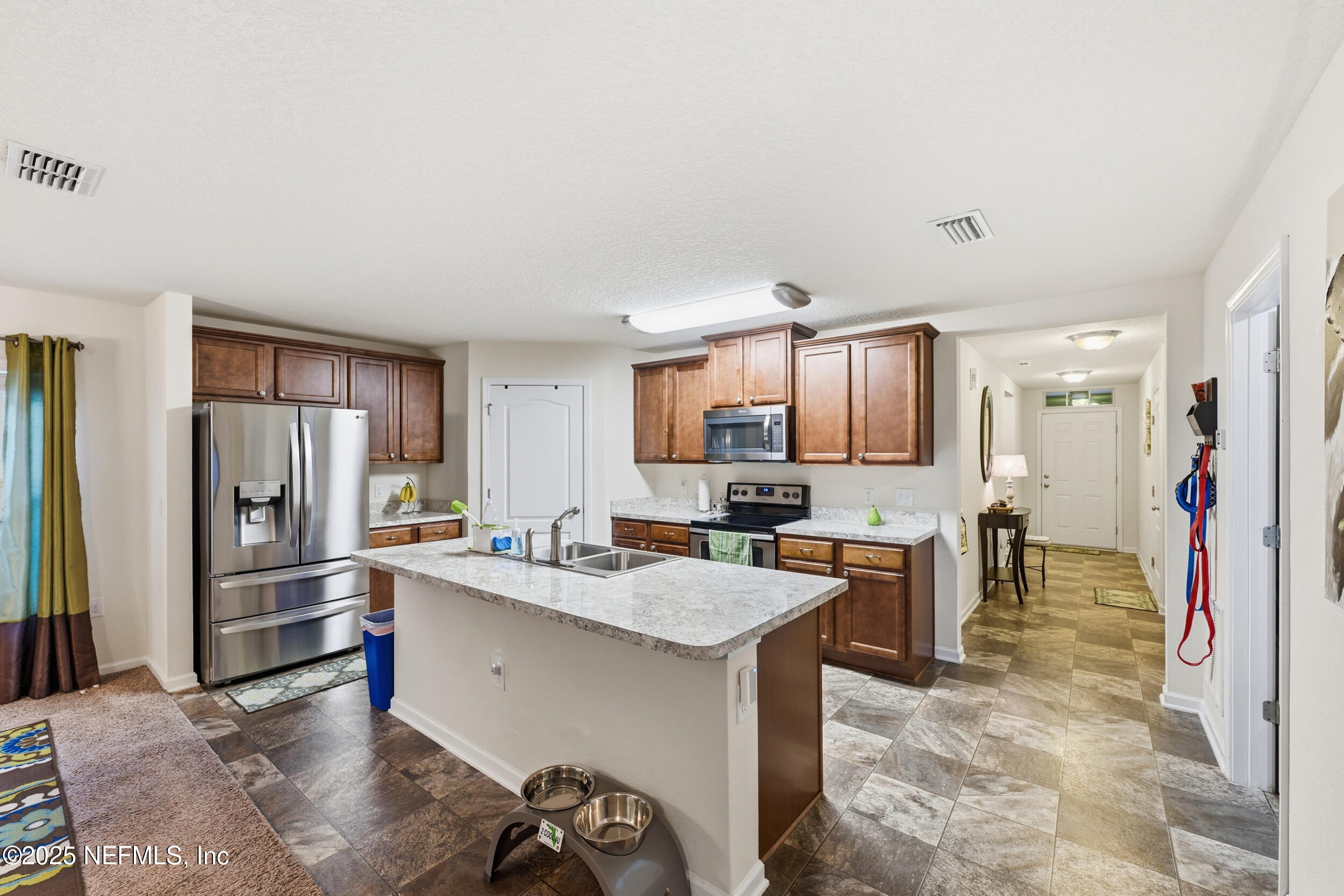 4068 Great Falls Loop Middleburg, FL 32068 - Photo 12 of 36 a kitchen with a sink refrigerator and cabinets