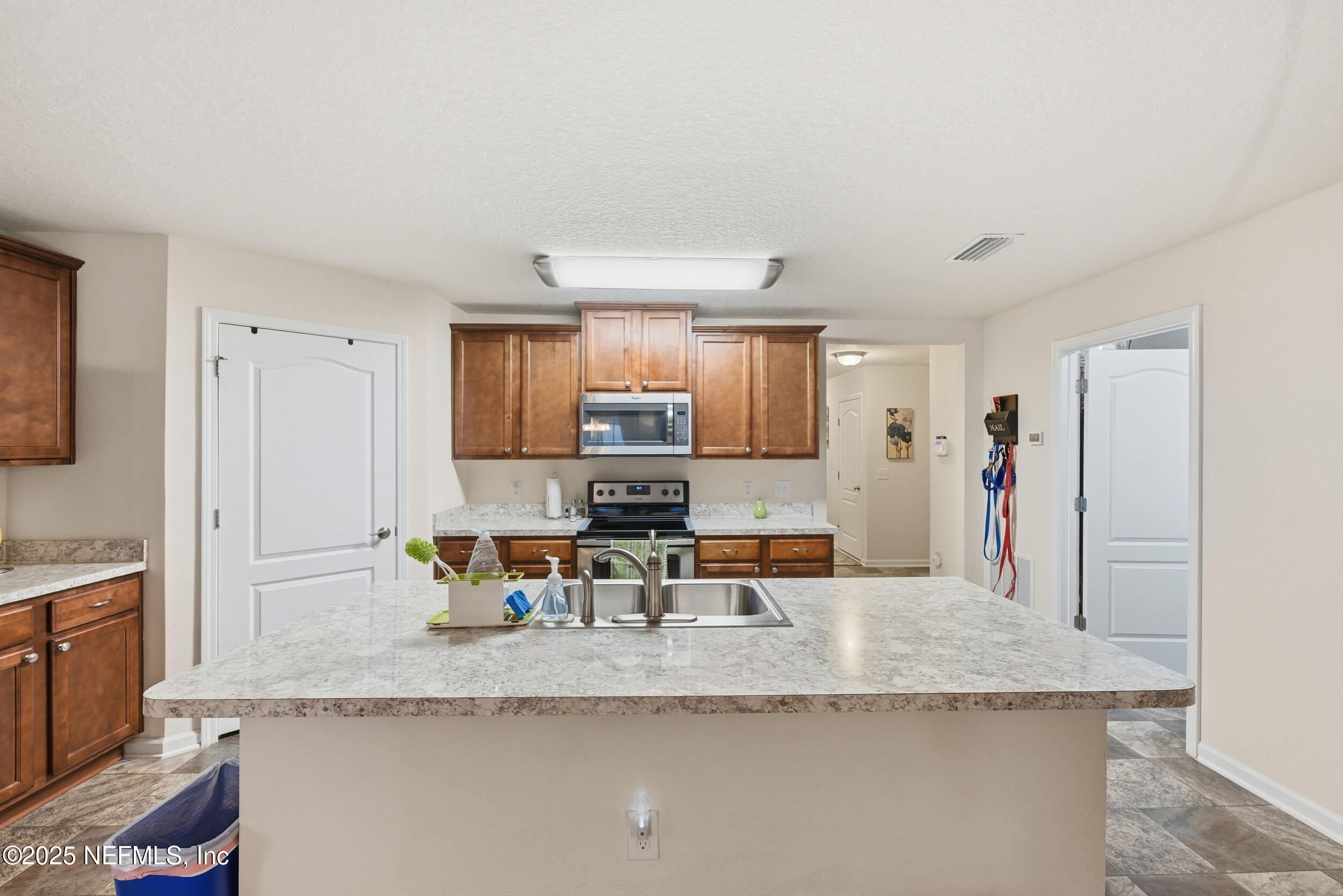 4068 Great Falls Loop Middleburg, FL 32068 - Photo 13 of 36 a kitchen with granite countertop a sink and cabinets
