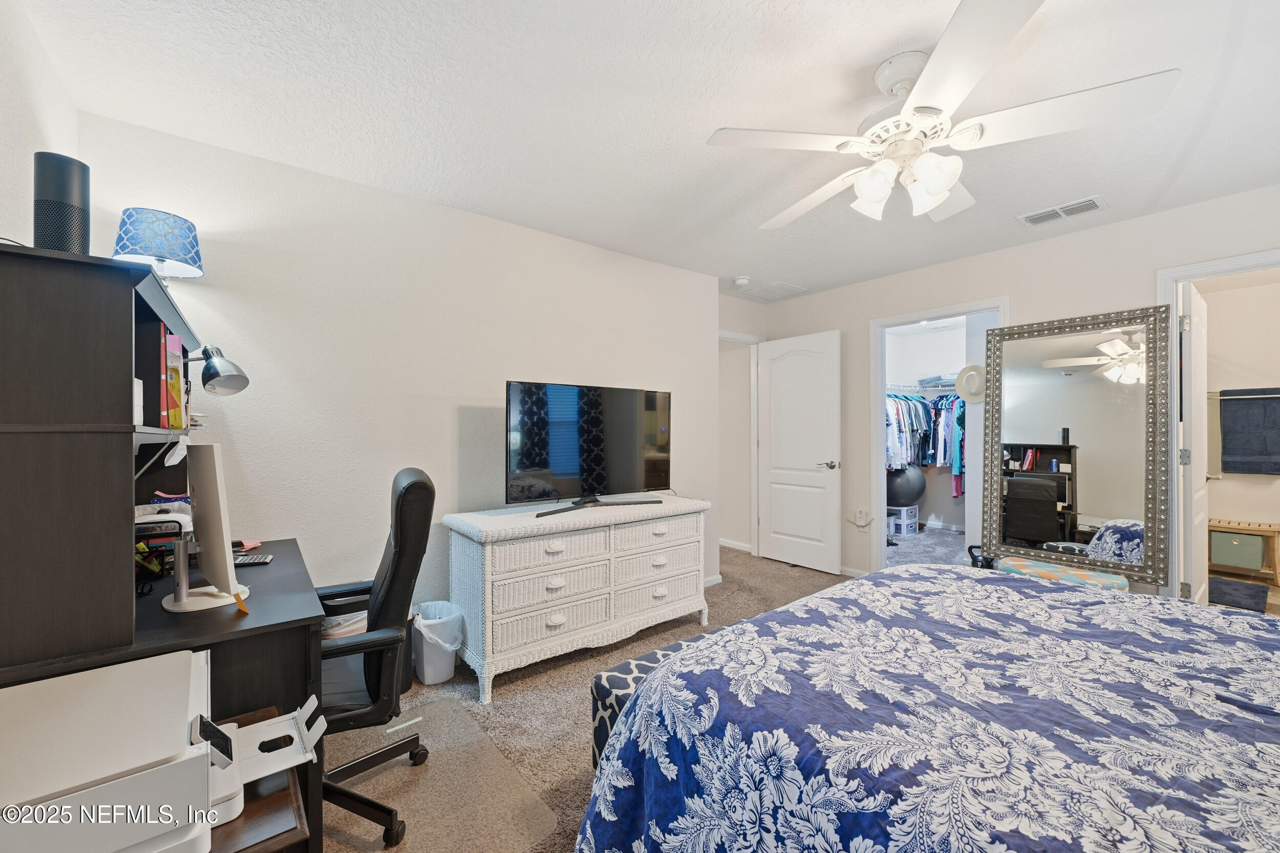 4068 Great Falls Loop Middleburg, FL 32068 - Photo 19 of 36 a bedroom with a bed and a flat screen tv