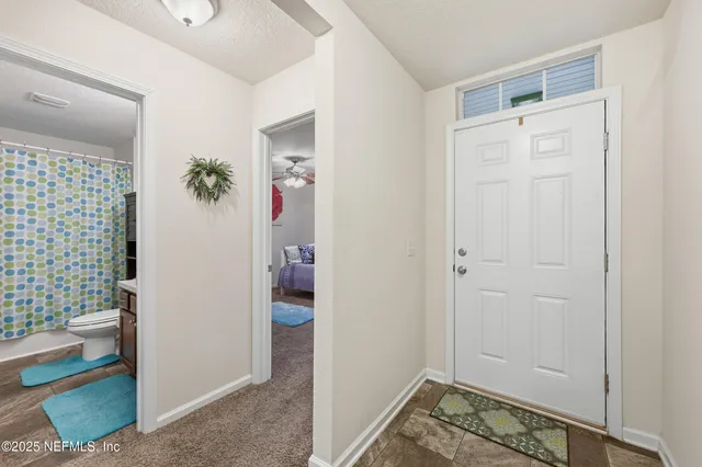 a view of an entryway with wooden floor