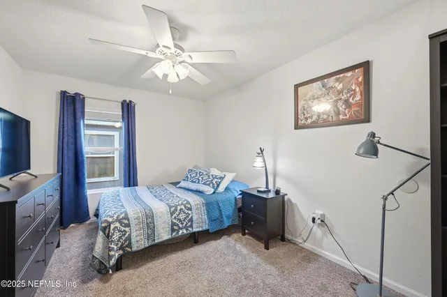 a bedroom with bed and a window