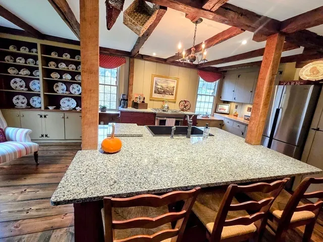 a kitchen table with chairs and wooden floor