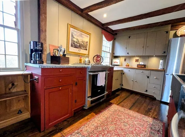 a kitchen with a sink stove and cabinets