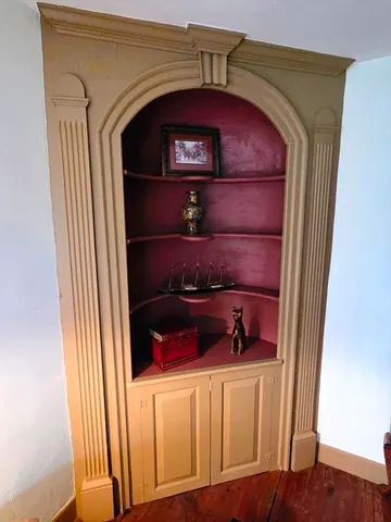 a close view of walk in closet with clothes and shoes