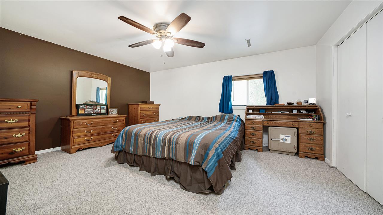 2436 South Ridge Road Oregon, IL 61061 - Photo 20 of 33 a bedroom with a bed and a chandelier