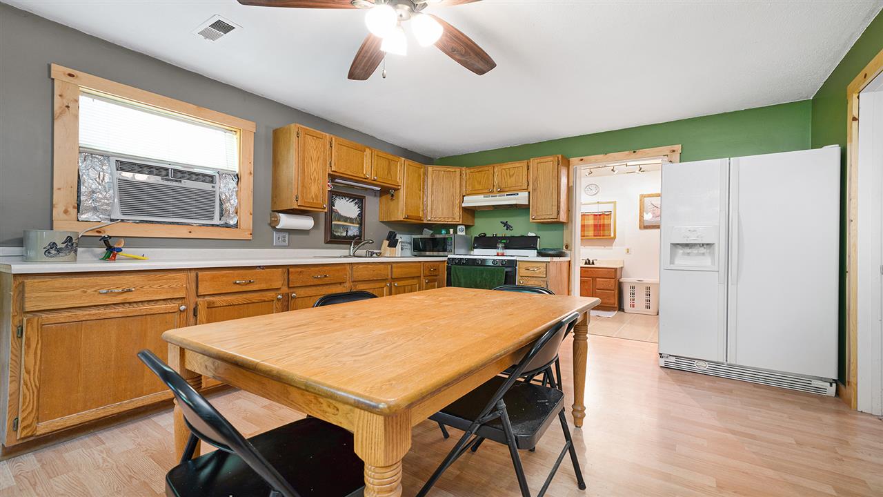 2436 South Ridge Road Oregon, IL 61061 - Photo 3 of 33 a kitchen with stainless steel appliances granite countertop a refrigerator a sink a stove a dining table and chairs