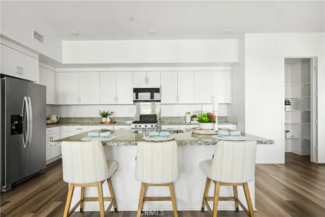 a large kitchen with granite countertop lots of counter top space