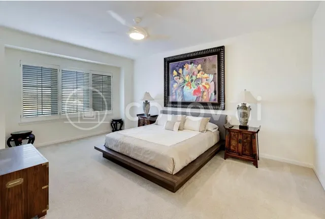 a spacious bedroom with a bed a couch and a window