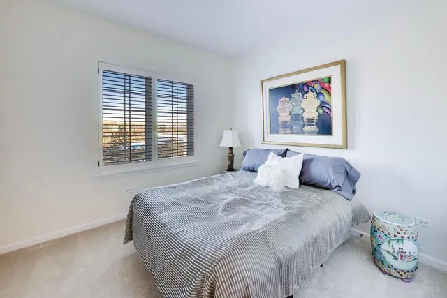 a bedroom with bed and a window