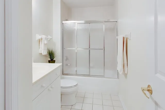 a bathroom with a sink a mirror and a potted plant